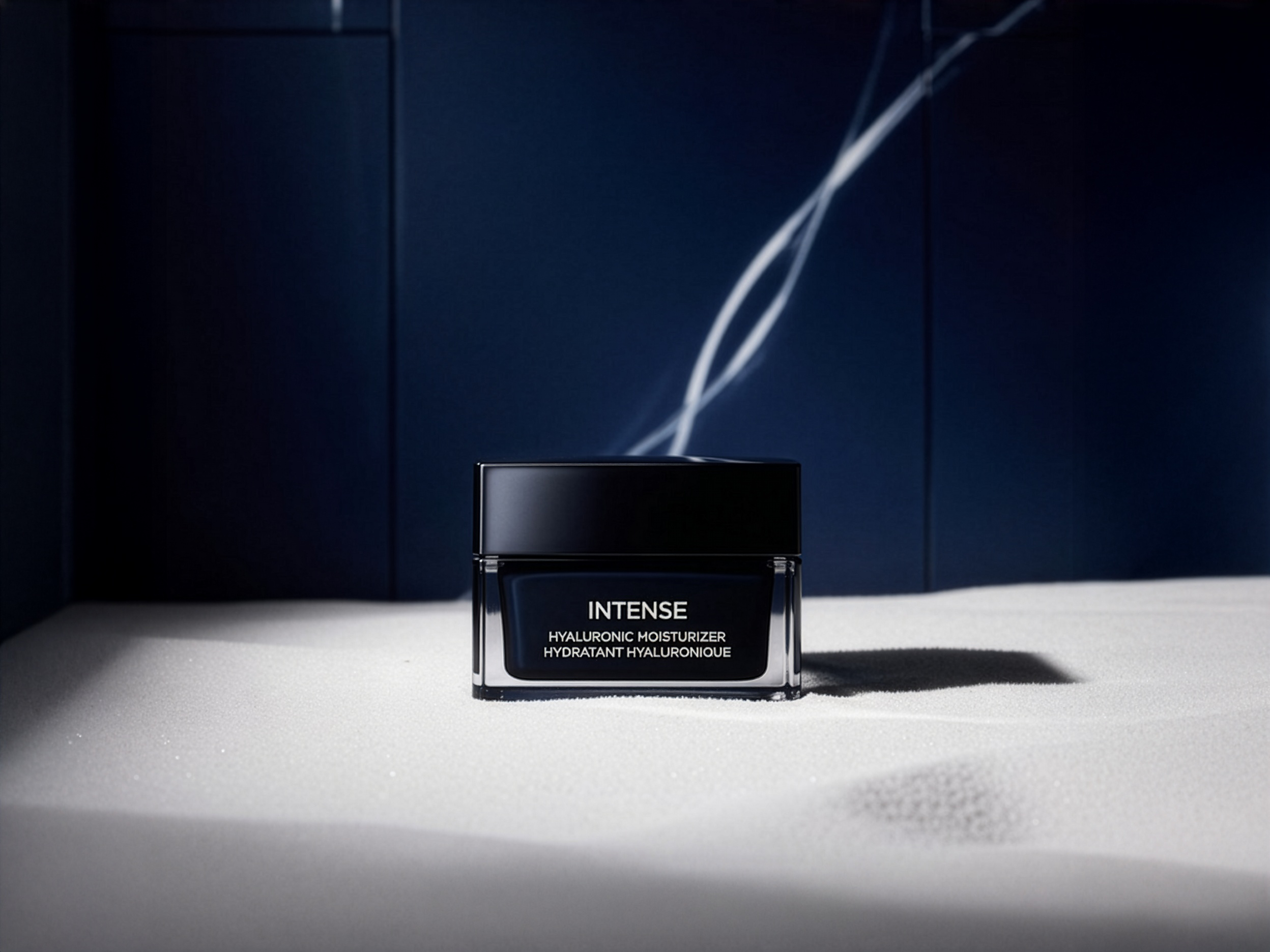 A jar of the Masculuxe Hyaluronic Moisturizer set on a white textured surface against a dark navy background with dramatic lighting.