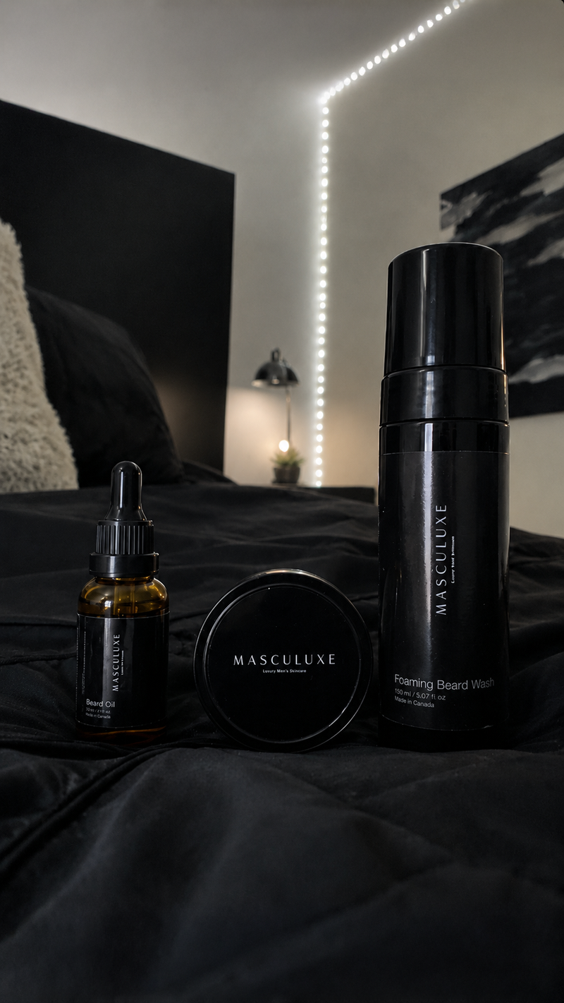 Three bottles of Masculuxe skincare products on a dark surface with a dimly lit background.